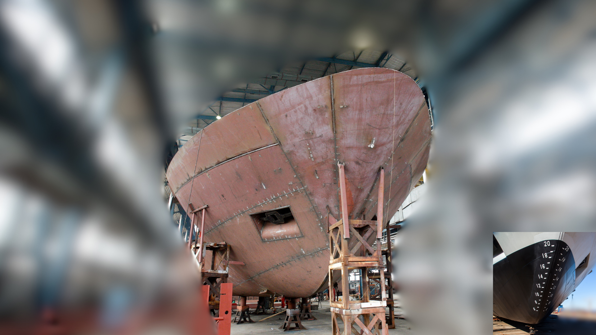 Actual steel hull of the 60-metre Whale Defense Agency APV under construction inside a shipyard, viewed from the bow
